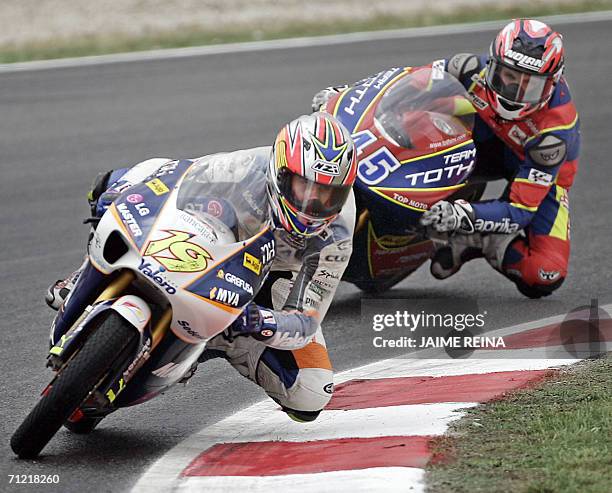 Spanish rider Alvaro Bautista rides 16 June 2006 in front of Hungarian Imre Toth during the first free practice session 125 c.c. Ahead of the 18 June...