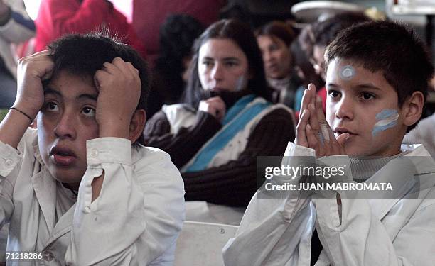 Schoolchildren from a public school of La Salada, Buenos Aires, Argentina, watch on TV a FIFA World Cup Germany 2006 match against Serbia &...