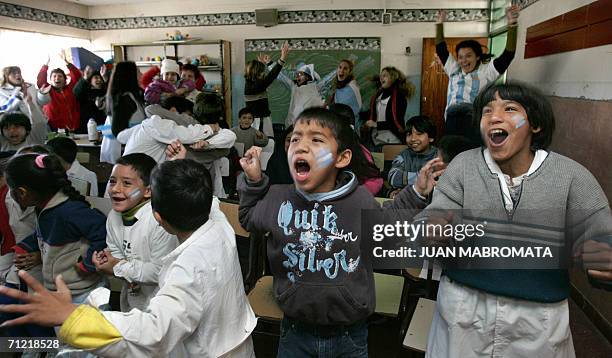 Schoolchildren and their teachers from a public school celebrate a goal in La Salada, Buenos Aires, Argentina, 16 June 2006, during a FIFA World Cup...