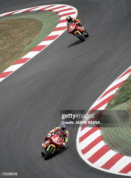 Spanish rider Alex Debon powers ahead of Spanish competitor Jorge Lorenzo during the 250cc free practice session ahead of the 18 June 2006 Catalonia...