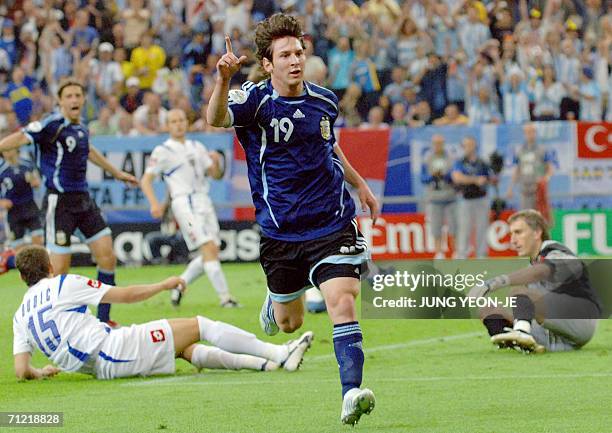 Argentinian forward Lionel Messi celebrates after scoring as Serbia and Montenegro's goalkeeper Dragoslav Jevric and Serbia and Montenegro's defender...