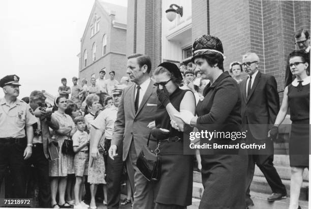 Mary Jo Kopechne's parents Joseph and Gwen walk down the steps, past other mourners and spectators, of St. Vincent's Roman Catholic Church after...