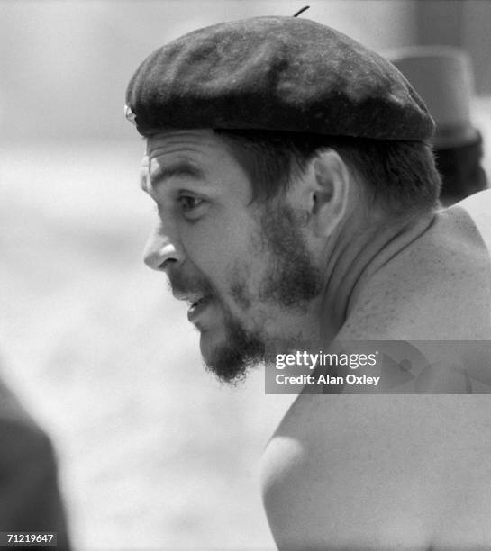 Stripped to the waist, Argentine-born revolutionary Ernesto Che Guevara , who waged guerrilla warfare with the Castro brothers, helps workers on a...