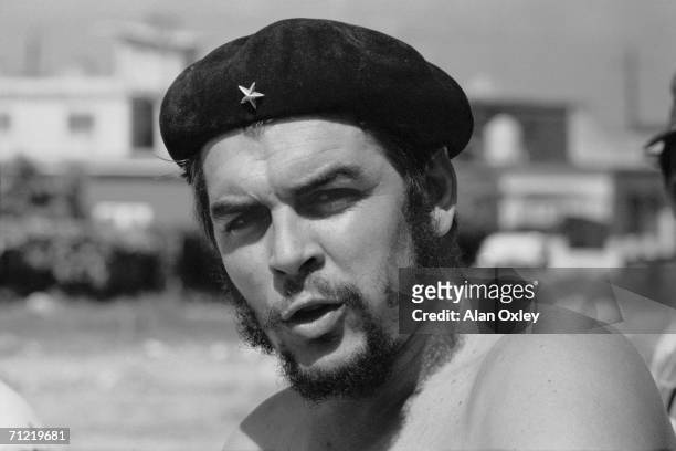 Stripped to the waist, Argentine-born revolutionary Ernesto Che Guevara , who waged guerrilla warfare with the Castro brothers, helps workers on a...
