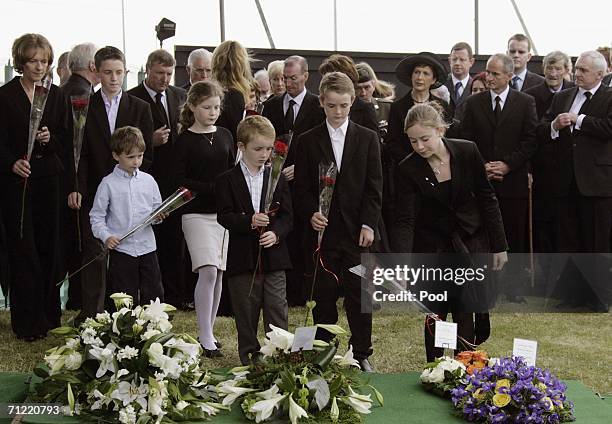 Former Irish Prime Minister Charles Haughey's grandchildren place flowers on his grave at the State Funeral at St. Fintans Cemetery on June 16, 2006...