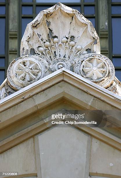 Paint chips and deterioration is shown on a decorative seashell molding that crowns of the entry ways to the Smithsonian Institution Arts and...