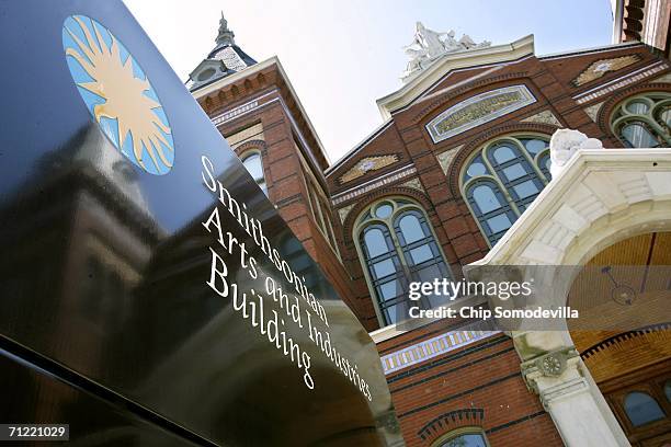 The Smithsonian Institution Arts and Industries Building is reflected in a sign along the National Mall June 16, 2006 in Washington, DC. Constructed...