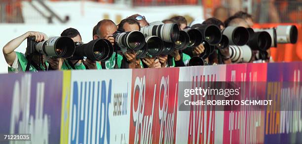 Press photographers are seen lined up during the opening round Group C World Cup football match between the Netherlands and Ivory Coast at...