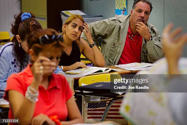 Ada Hernandez from Cuba and Jose Louzao from Argentina listen to their teacher Radka Tomasek as they learn how to speak English at the English Center...