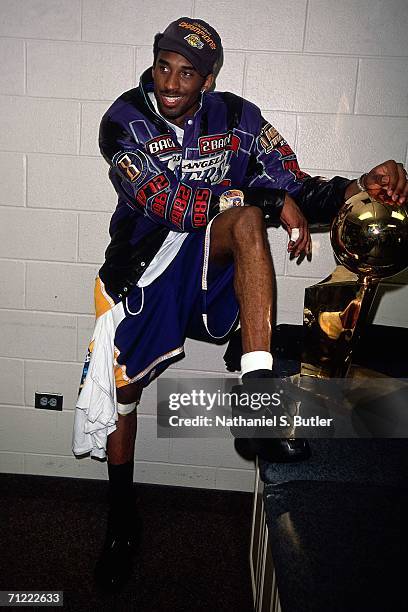 Kobe Bryant of the Los Angeles Lakers poses with the NBA Championship trophy after winning the 2001 NBA Championship by defeating the Philadelphia...