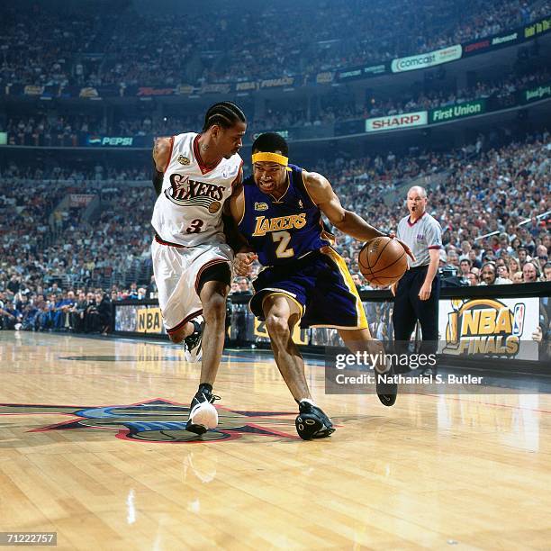 Derek Fisher of the Los Angeles Lakers drives to the basket against Allen Iverson of the Philadelphia 76ers during game five of the NBA FInals June...