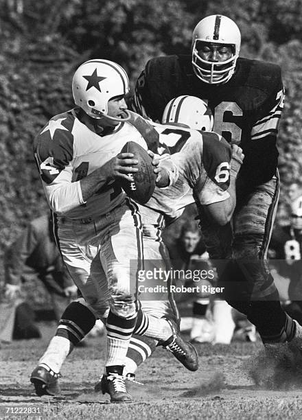 American football player Gene "Big Daddy" Lipscomb, defensive tackle for the Pittsburgh Steelers, goes after a sack on Dallas Cowboys quarterback...