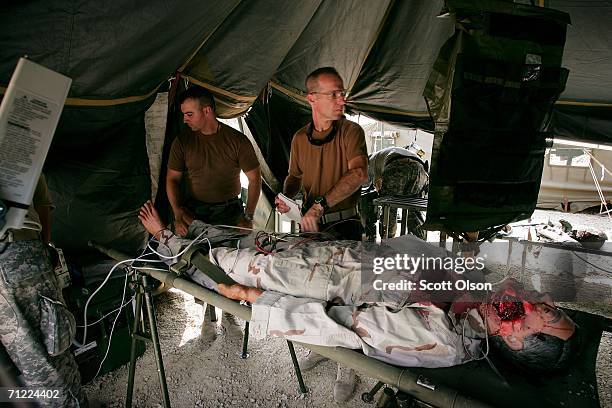 Sgt. Jason Meeks of Belleview, Florida and 1st Lt. Lee Percy of Pensacola, Florida work on a simulated casualty as they train with the 946th Forward...