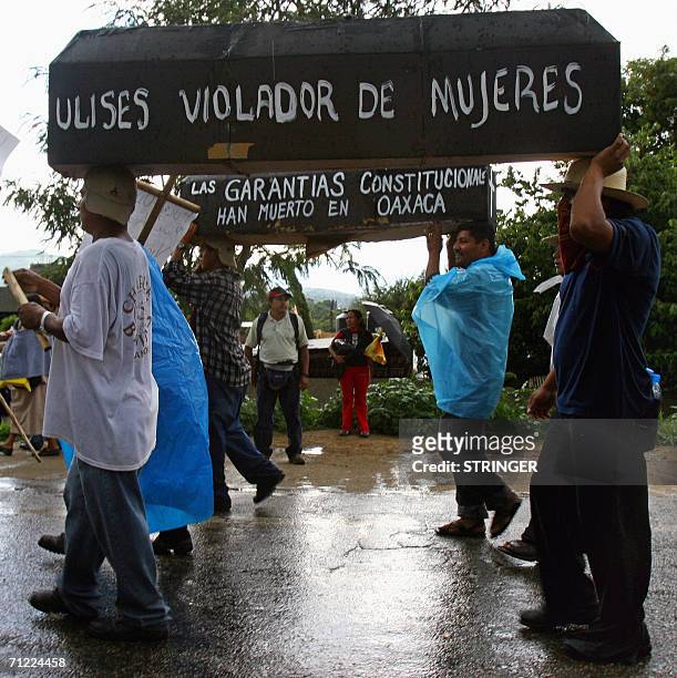 Teachers carry mock coffins as they march to Oaxaca's centre with thousands of collegues on June 16th demanding the resignation of Governor Ulises...