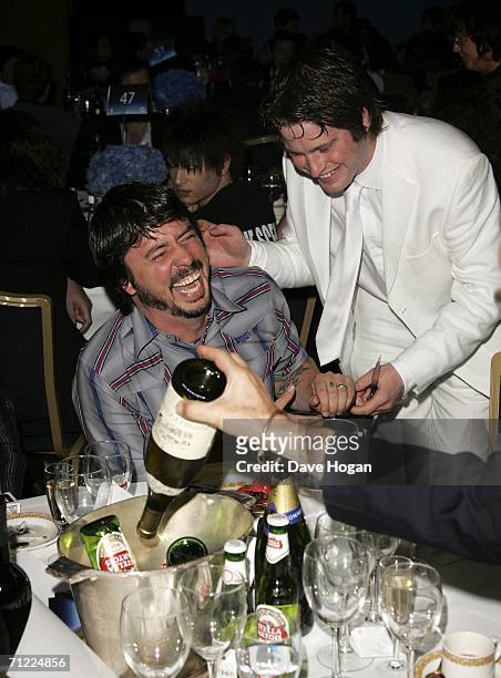 Foo Fighters frontman Dave Grohl partakes in a magic trick with magician Paul Lytton at the O2 Silver Clef Lunch, an annual awards honouring...