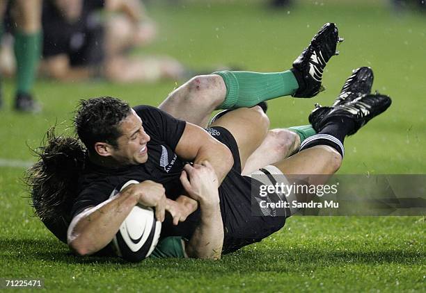 Brian O'Driscoll of Ireland fails to stop Luke MacAlister of New Zealand diving over the line to score a try during the international test match...