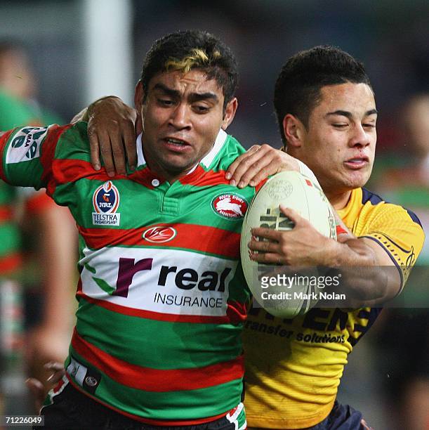 Nathan Merritt of the Rabbitohs is tackled by Jarryd Hayne of the Eels during the round 15 NRL match between the Parramatta Eels and the South Sydney...