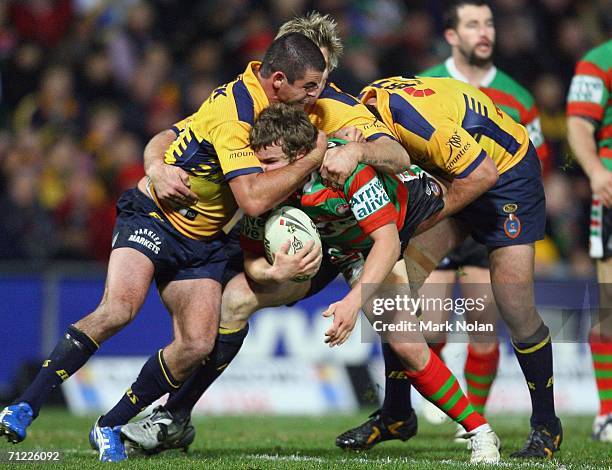 Luke MacDougall of the Rabbitohs is tackled during the round 15 NRL match between the Parramatta Eels and the South Sydney Rabbitohs played at...