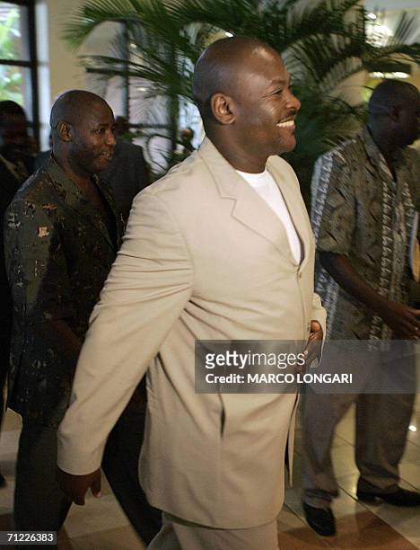 Dar es Salaam, TANZANIA, UNITED REPUBLIC OF: Burundi President Pierre Nkurunziza is welcomed by members of his staff 17 June 2006 on his arrival at...