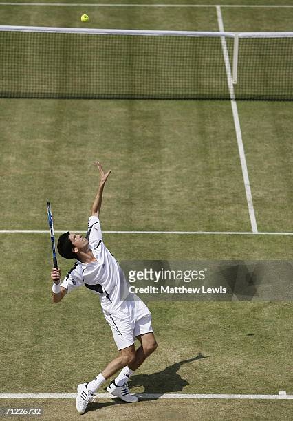 Tim Henman of Great Britain serves against Lleyton Hewitt of Australia during Day 6 of the Stella Artois Championships at Queen's Club on June 17,...