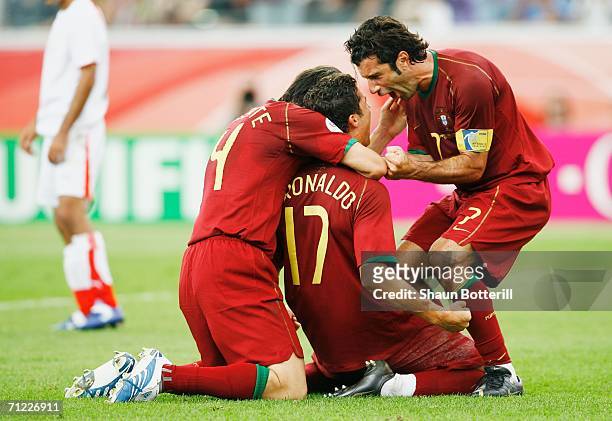 Cristiano Ronaldo of Portugal celebrates with team mates Luis Figo and Nuno Valente after scoring his team's second goal from the penalty spot during...