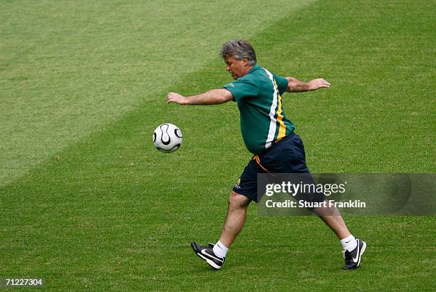 Australian coach Gus Hiddink kicks a ball during the training session of the Australian National Team at the stadium Munich for the FIFA World Cup...