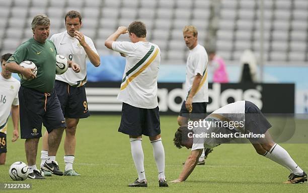 Australian coach Guus Hiddink talks to his players during the Australian training session at the Stadium Munich June 17, 2006 in Munich, Germany.