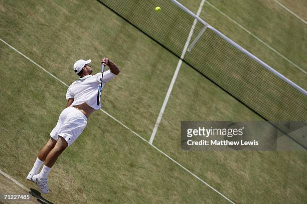 Andy Roddick of the United States serves against James Blake of the United States during Day 6 of the Stella Artois Championships at Queen's Club on...
