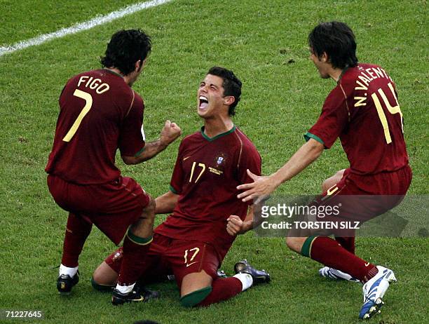 Frankfurt am Main, GERMANY: Portuguese forward Cristiano Ronaldo celebrates his goal against Iran with teammates Luis Figo and Nuno Valente during...