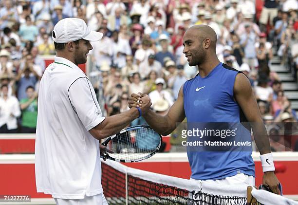 James Blake of the United States is congratulated by Andy Roddick of the United States during Day 6 of the Stella Artois Championships at Queen's...