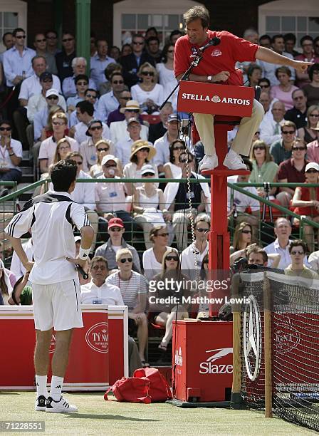Tim Henman of Great Britain talks to the umpire against Lleyton Hewitt of Australia during Day 6 of the Stella Artois Championships at Queen's Club...