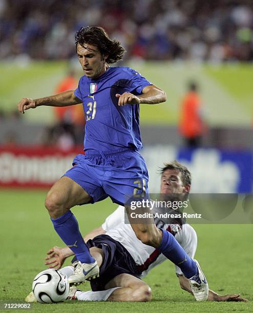 Andrea Pirlo of Italy is tackled by Brian McBride of the USA during the FIFA World Cup Germany 2006 Group E match between Italy and USA at the...