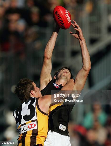 Ray Hall of the Tigers marks in front of Ben McGlynn of the Hawks during the round 12 AFL match between the Hawthorn Hawks and the Richmond Tigers at...
