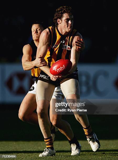 Jarryd Roughead of the Hawks is tackled by Nathan Brown of the Tigers during the round 12 AFL match between the Hawthorn Hawks and the Richmond...