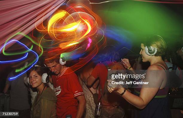 People dance at the silent disco during the second day at the 2006 Bonnaroo Music & Arts Festival on June 17, 2006 in Manchester, Tennessee. The...