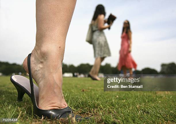 Woman treads in divots during the half time break of The Cartier Cup between Talandracas and Cadenza at Guards Polo Club on June 18, 2006 in Windsor,...