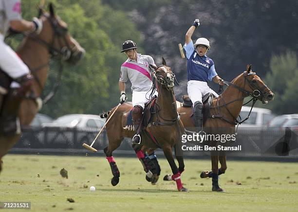 Alejandro Mussio and Guillermo Willington compete during The Cartier Cup between Talandracas and Cadenza at Guards Polo Club on June 18, 2006 in...