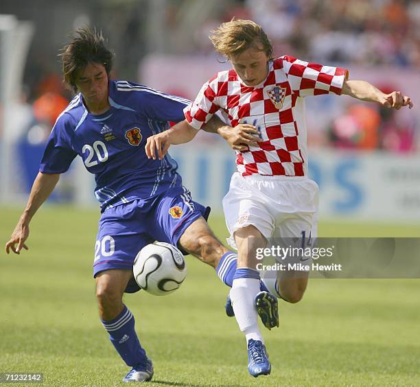 Luka Modric of Croatia is tackled by Keiji Tamada of Japan during the FIFA World Cup Germany 2006 Group F match between Japan and Croatia at the...