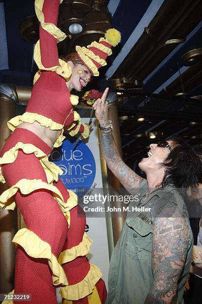 Nikki Sixx has some fun with one of clowns on stilts as he arrives at the 4th Annual Friends Of El Faro Fundraiser being held at the Music Box at the...