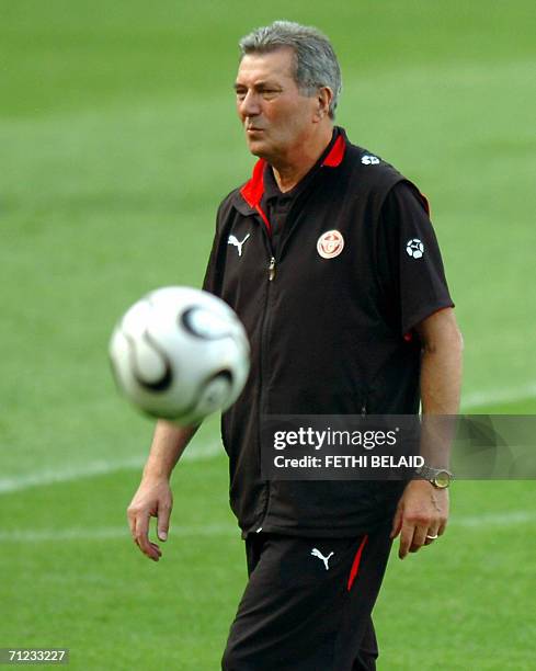 French head coach of the Tunisian team Roger Lemerre watches his players during a training session at The Gottlieb-Daimler Stadium in Stuttgart, 18...