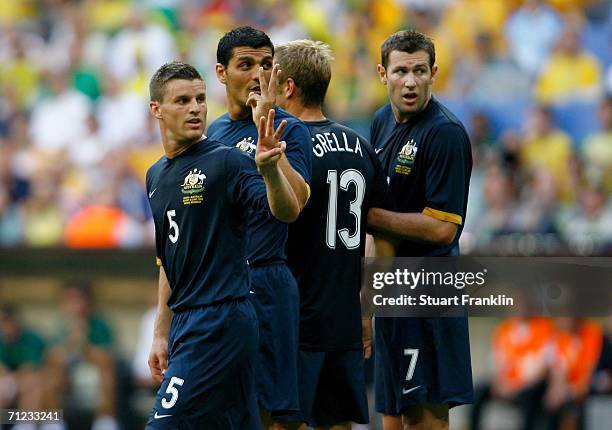 Jason Culina, John Aloisi, Vince Grella and Brett Emerton of Australia stand in a defensive wall during the FIFA World Cup Germany 2006 Group F match...