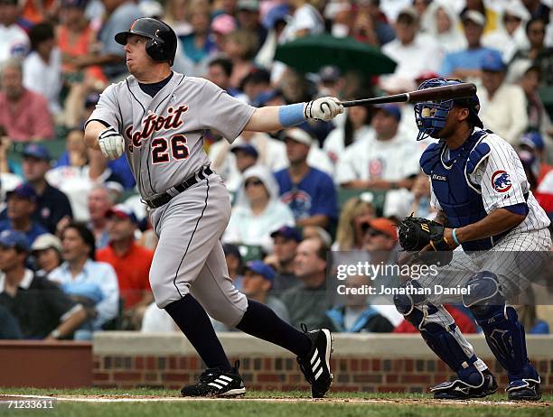 Chris Shelton of the Detroit Tigers hits a two-run home run in the first inning against Mark Prior of the Chicago Cubs as catcher Henry Blanco...