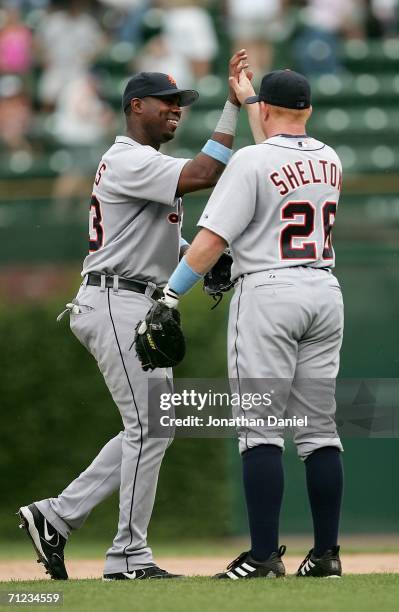 Marcus Thames of the Detroit Tigers congratulates teammate Chris Shelton after the Tigers swept a series against the Chicago Cubs on June 18, 2006 at...