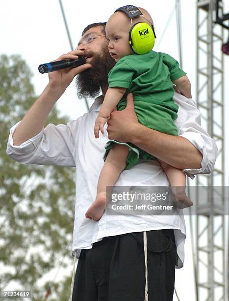 Rapper Matisyahu holds his 10 month-old son Levi Yitzhak while performing on Father's Day during the final day of the 2006 Bonnaroo Music & Arts...