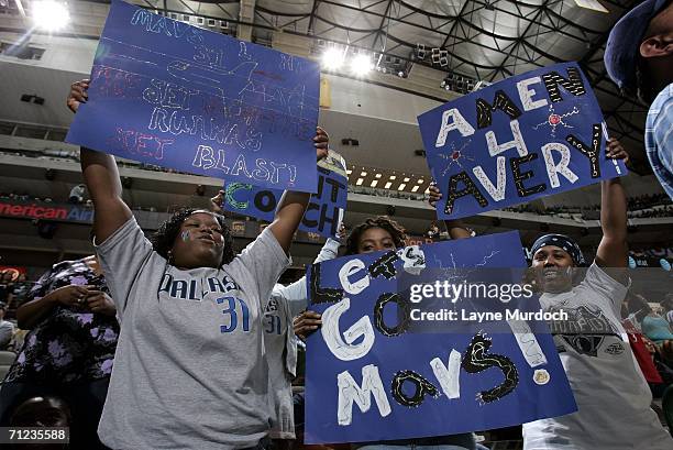 Fans of the Dallas Mavericks watch the televised broadcast of Game Five of the 2006 NBA Finals against the Miami Heat on the scoreboard of the...