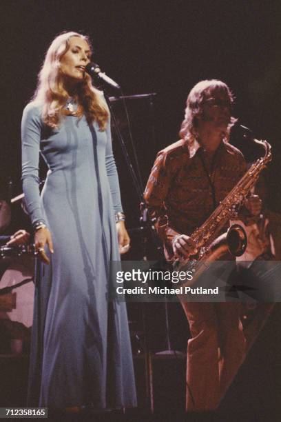 Canadian singer and songwriter Joni Mitchell performs live on stage with Tom Scott of LA Express at the New Victoria Theatre in London on 20th March...