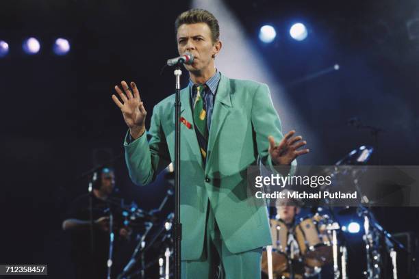 David Bowie performs on stage at the Freddie Mercury Tribute Concert for AIDS Awareness, Wembley Stadium, London, 20th April 1992. Queen drummer...