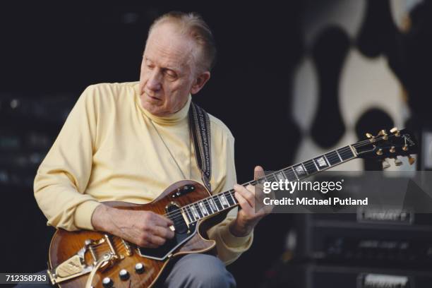 American jazz musician Les Paul performs live on stage playing a Gibson guitar at the Guitar Legends concert in Seville, Spain in October 1991.