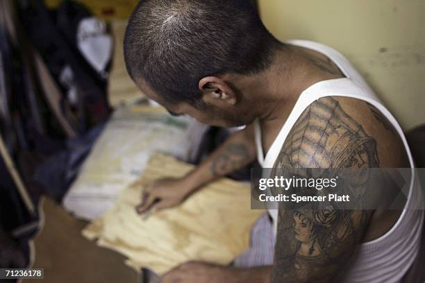 Francisco works on a wood carving in a work-shop in a halfway house for migrants in distress on June 18, 2006 in Naco Sanora, Mexico. The home...