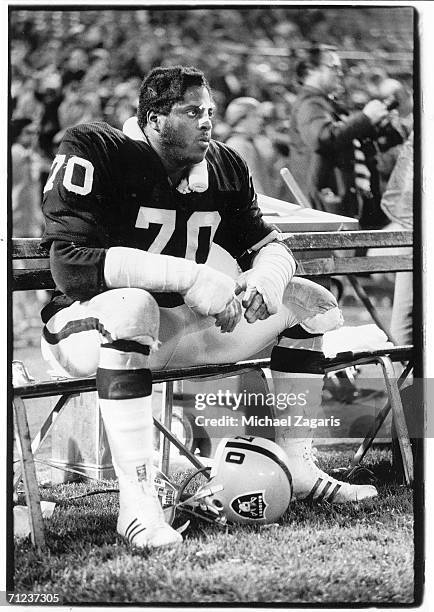 Offensive tackle Henry Lawrence of the Oakland Raiders sits on the bench during the game against the Buffalo Bills at Oakland-Alameda County Coliseum...